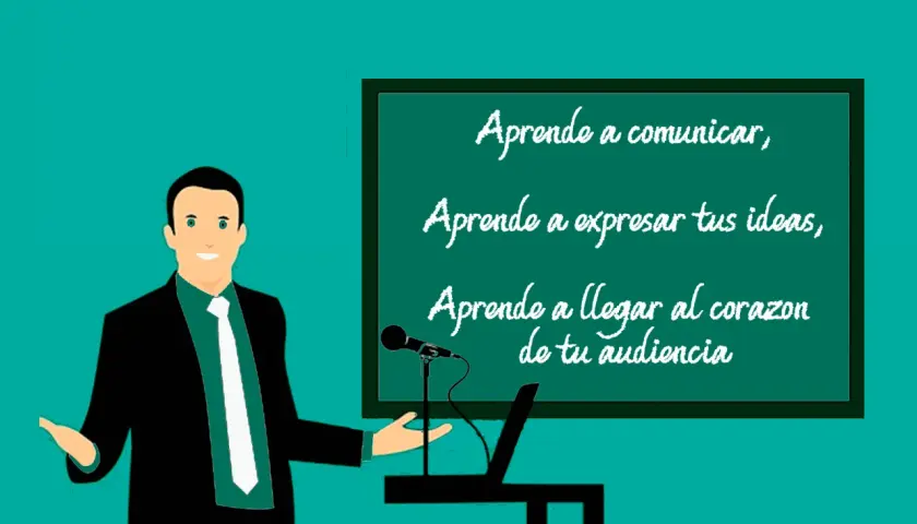 Un orador sonriente, con un traje negro y corbata blanca, presenta en una pizarra. La pizarra muestra un ejemplo de qué es una anáfora: "Aprende a comunicar, Aprende a expresar tus ideas, Aprende a llegar al corazón de tu audiencia".