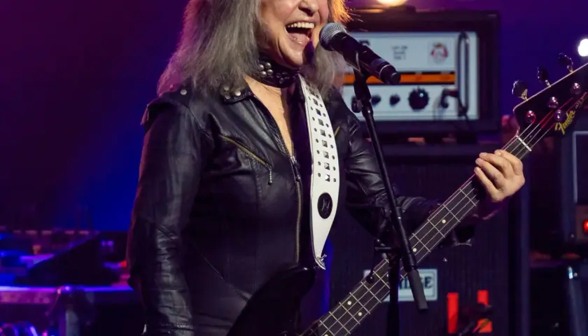 Suzi Quatro, w czarnej ramonesce, gra na basie i śpiewa. Ile lat ma Suzi Quatro? Wciąż pełna energii na scenie!