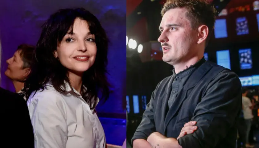 Dawid Podsiadło i jego partnerka, uśmiechnięta kobieta w białej koszuli, obok niego mężczyzna w czarnej marynarce.