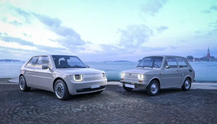 Nowy Fiat 126p obok swojego klasycznego poprzednika, na tle wodnego miasta.
