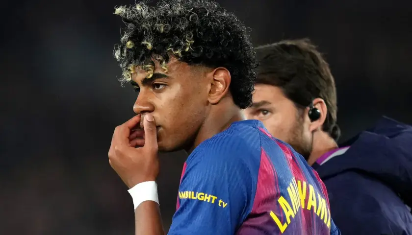 Młody piłkarz Lamine Yamal z FC Barcelony, z charakterystyczną fryzurą, zamyślony, być może po kontuzji.