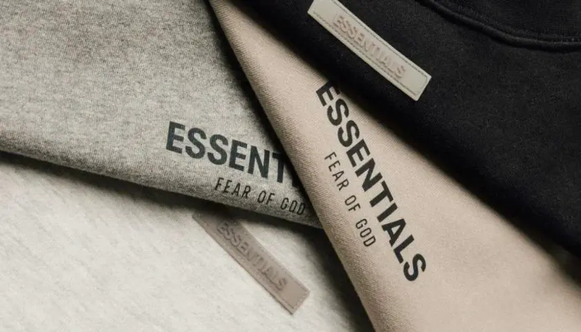 Szare, beżowe i czarne ubrania z logo Essentials. To marka Fear of God, znana z minimalistycznych projektów.