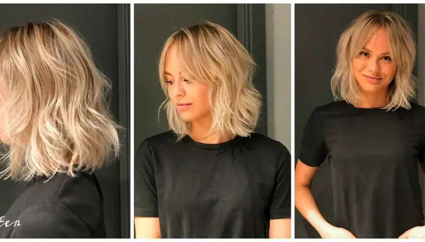 En kvinna med blont, vågigt hår och lugg. Denna page frisyr är stylad med textur och volym.