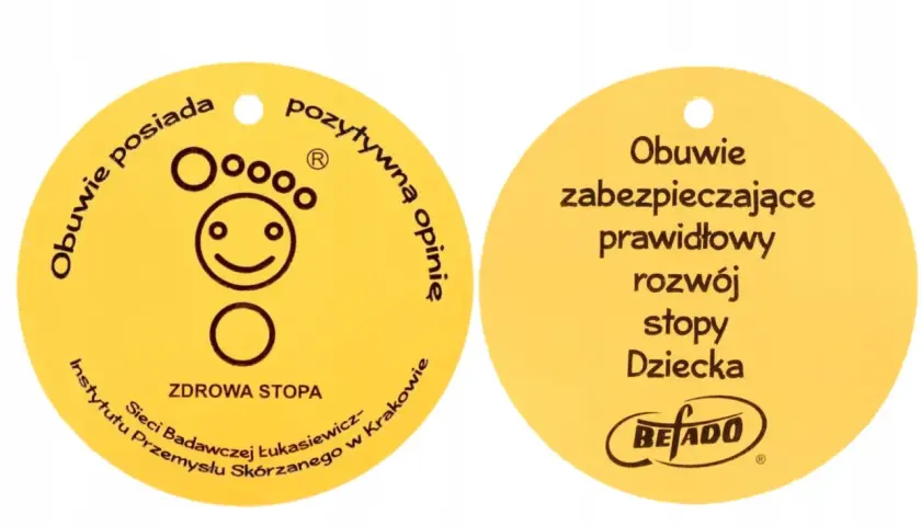 Żółty certyfikat "Zdrowa Stopa" z symbolem uśmiechniętej stopy i napisem "Obuwie zabezpieczające prawidłowy rozwój stopy Dziecka".