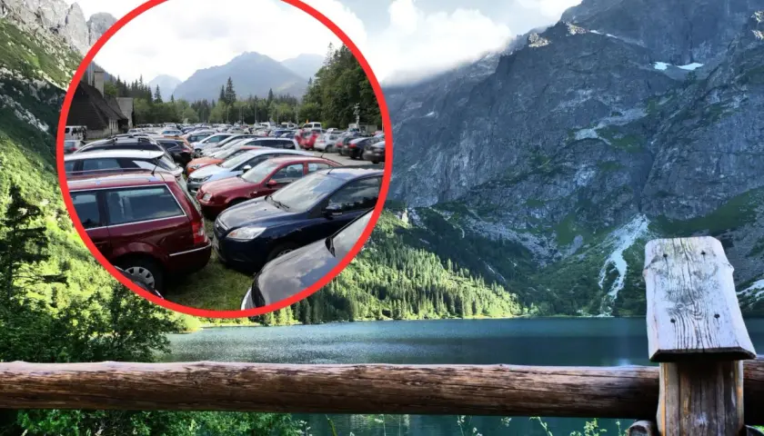 Tłok samochodów na parkingu pod Morskim Okiem. W tle piękne góry i jezioro.