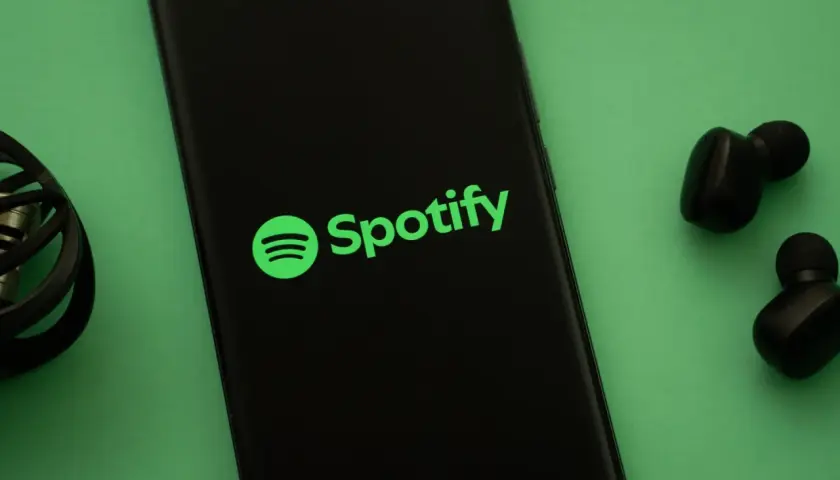 Telefon z logo Spotify i słuchawkami. Słuchaj muzyki na Spotify za darmo!