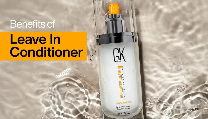 Un spray leave in para el cabello GK Hair, que promete beneficios para el pelo, descansa sobre una superficie con agua.