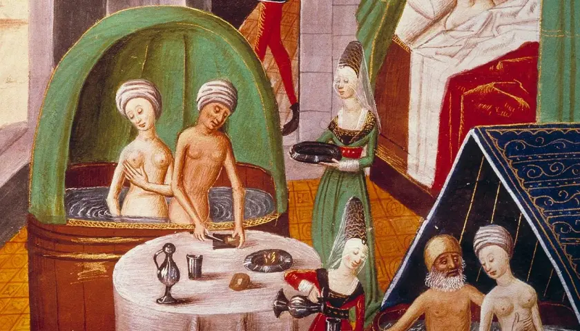 Miniatura średniowieczna: kobiety i mężczyzna w kąpieli, kobiety podają napoje.
