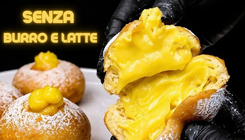 Bomboloni alla crema, soffici e ripieni, senza burro e latte. Un dolce invitante, pronto per essere gustato.