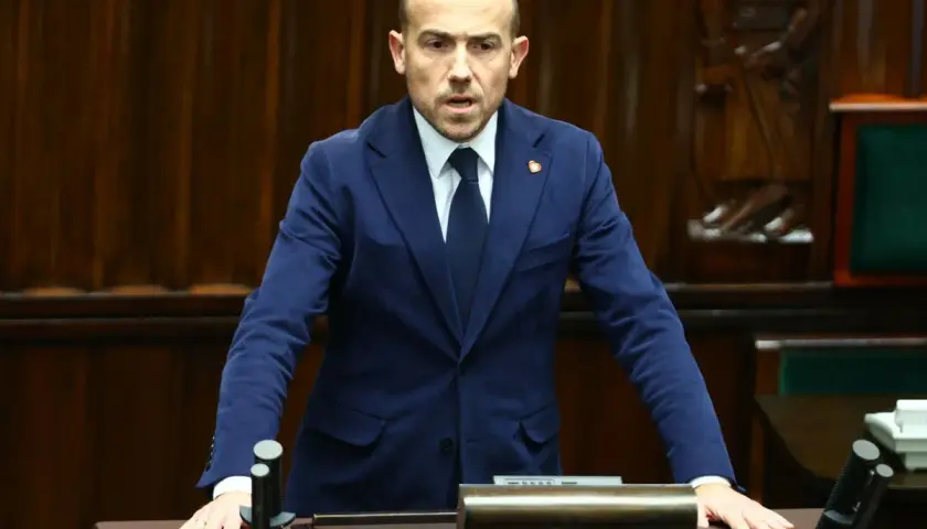 Borys Budka, polityk, przemawia w sejmie. Jego wiek nie jest widoczny, ale jego postawa sugeruje doświadczenie.