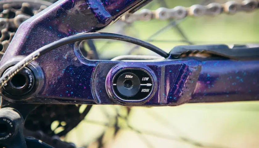 Close-up of a purple speckled flip chip mtb frame, showing adjustment settings for geometry.