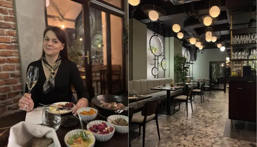 Kobieta z kieliszkiem wina w jednej z **ciekawych restauracji okolic Krakowa**. Wnętrze lokalu z nowoczesnym designem i eleganckimi lampami.
