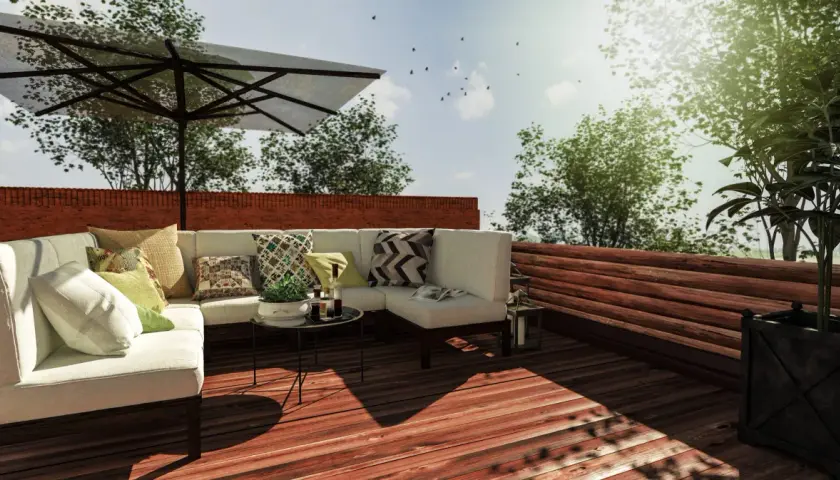 Aménagement toit terrasse avec canapé, parasol et vue sur la verdure. Un projet qui demande une autorisation.