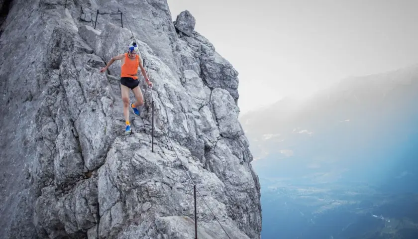 Anton Palzer bezwingt den Watzmann im Laufschritt. Ein Trailrunner in Aktion auf steilem Fels mit Seilsicherung.