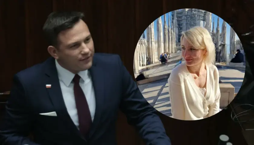 Sławomir Mentzen w garniturze i jego żona uśmiechają się na tle katedry.
