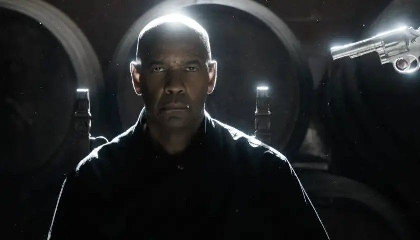 Denzel Washington w filmie "Bez litości 4" z rewolwerem w dłoni, gotowy do akcji.