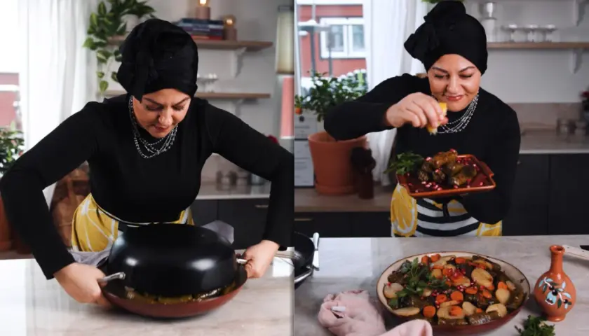 Kvinna i kök förbereder warak enab, fyllda vinblad med ris och grönsaker, och garnerar med granatäpple.