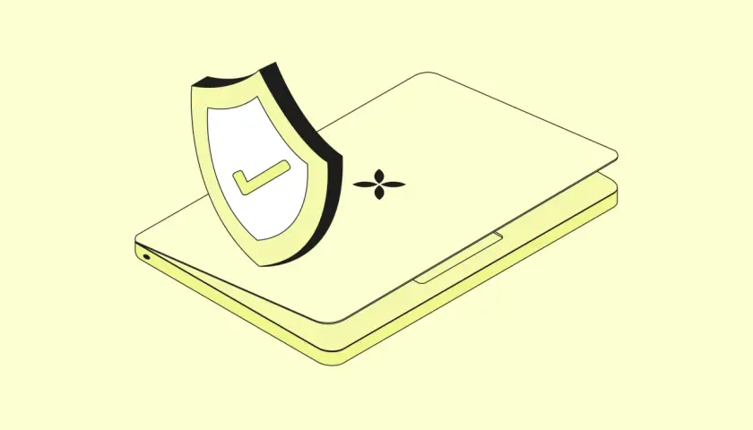 Ein Laptop mit einem Schild und einem Häkchen, das Schutz vor Internet-Betrug symbolisiert.