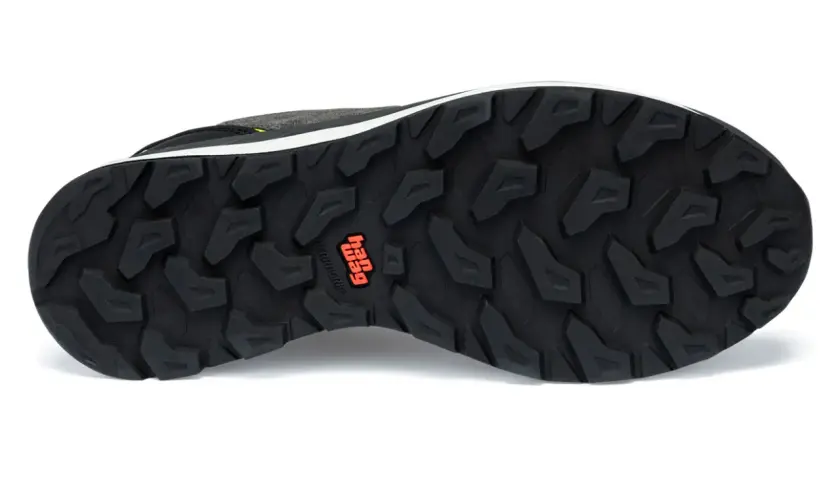 The black outsoles of a hiking shoe feature a deep, aggressive tread pattern for maximum grip. The "Hag" logo is visible in orange.