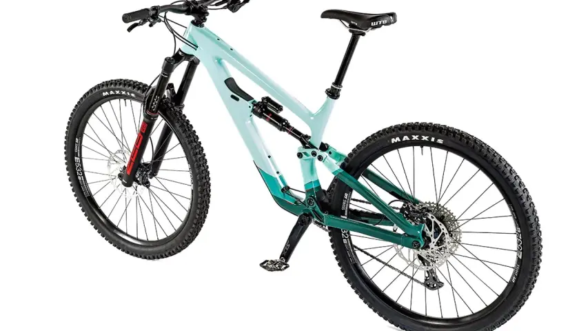 A teal and green full-suspension mountain bike, possibly a Salsa Cassidy, with Maxxis tires and a WTB saddle, ready for any trail.