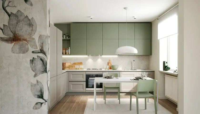 Cucina moderna con pensili color verde salvia, un murale floreale e un tavolo con sedie verdi.