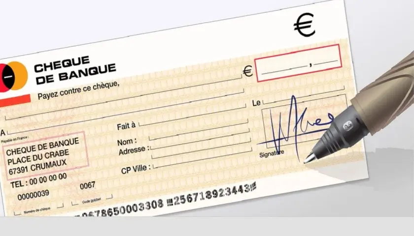 Un stylo est prêt à vérifier un chèque de banque. Les détails du chèque sont visibles, y compris le nom de la banque et le montant en euros.