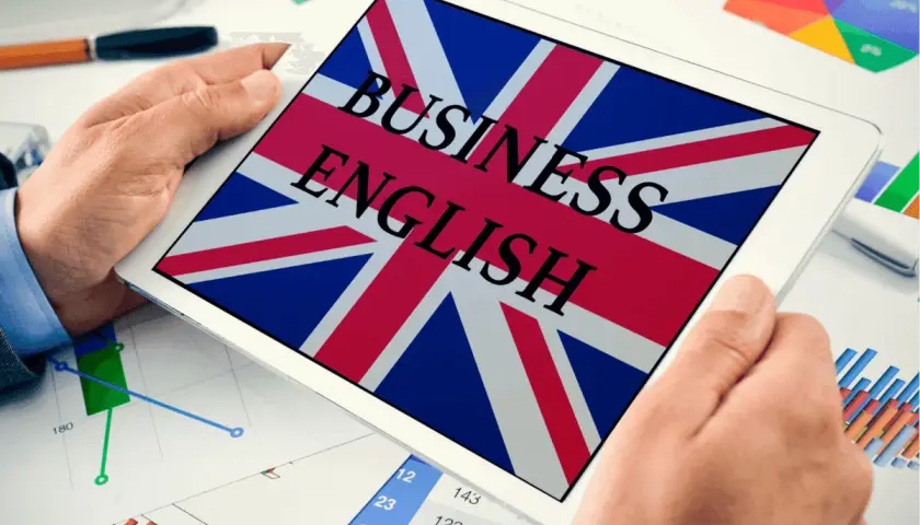 Tablet z flagą Wielkiej Brytanii i napisem "BUSINESS ENGLISH". Idealny do nauki przydatnych zwrotów po angielsku w biznesie.