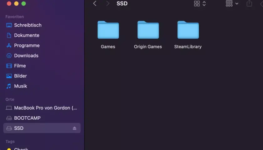 Auf dem Mac wird die externe Festplatte "SSD" mit den Ordnern "Games", "Origin Games" und "SteamLibrary" angezeigt.