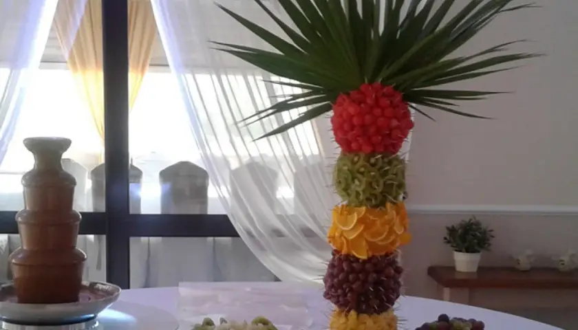 Kolorowa wieża z owoców: maliny, kiwi, pomarańcze, winogrona, ananas. Idealne jakie owoce do fontanny czekoladowej.