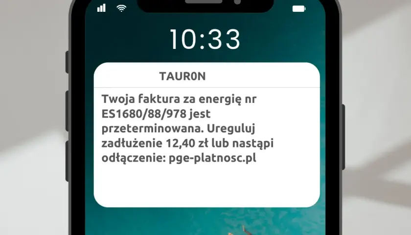 Ostrzeżenie przed smishingiem: fałszywa wiadomość od TAURON informuje o zaległej fakturze i grozi odłączeniem prądu, kierując na podejrzaną stronę.