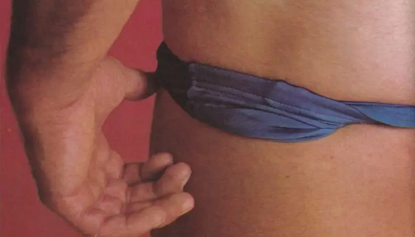 Mano che stringe un laccio blu, evocando il kink significato di piacere e trasgressione.