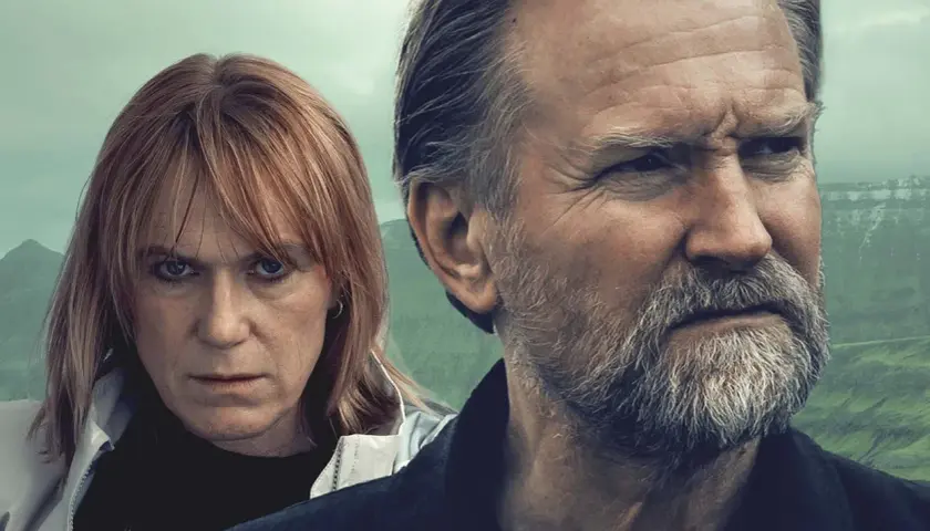 Två ansikten, en kvinna med rött hår och en man med grått skägg, tittar ut över ett dimmigt landskap. En scen från en spännande trom serie.