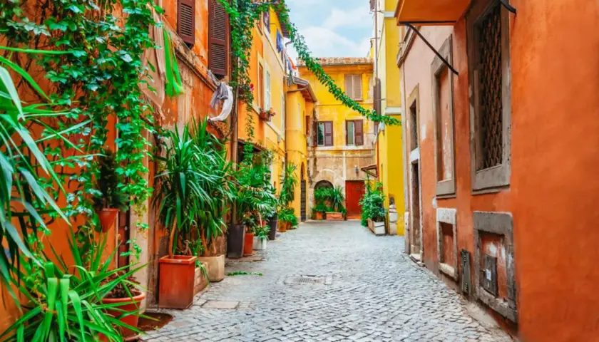 Un vicolo fiorito a Trastevere, Roma. Un angolo pittoresco per scoprire cosa vedere in questo quartiere storico.