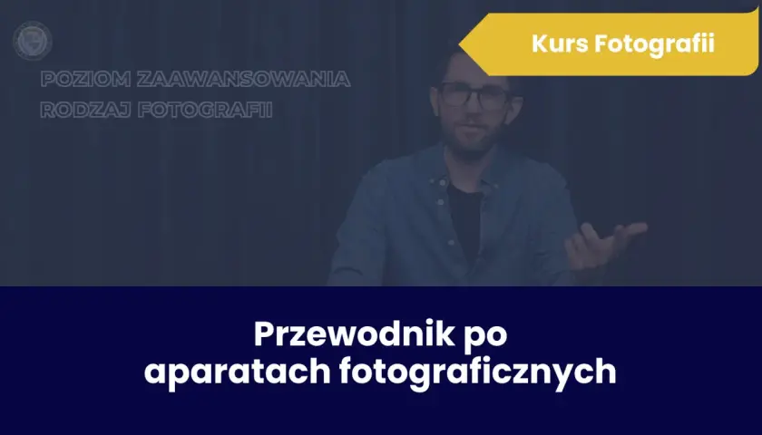 Mężczyzna w okularach prowadzi kurs fotografii. Na ekranie widnieje napis "Przewodnik po aparatach fotograficznych".