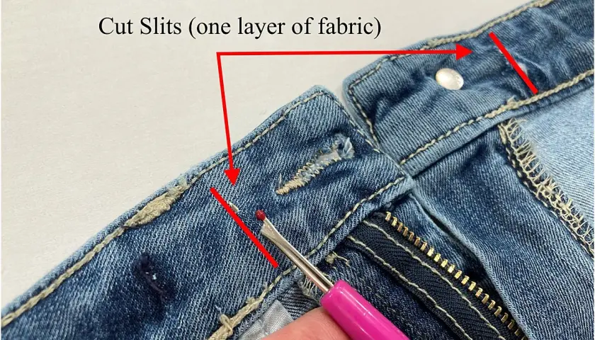 Demonstration of how to take in jeans at the waist by cutting slits in the fabric.