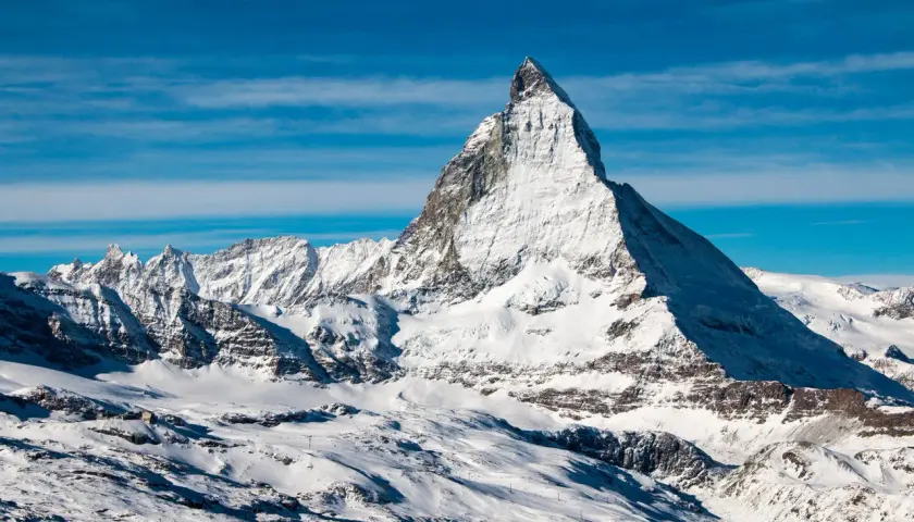 Majestatyczny Matterhorn w śnieżnej szacie, zapraszający do wejścia na szczyt.