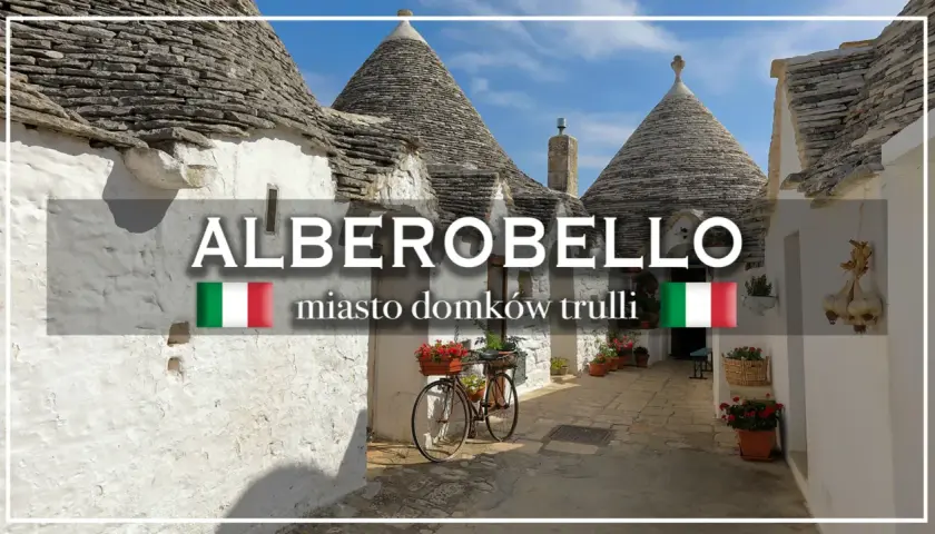 Alberobello, miasto domków trulli, z rowerem ozdobionym kwiatami i wiszącą na ścianie czosnkiem.