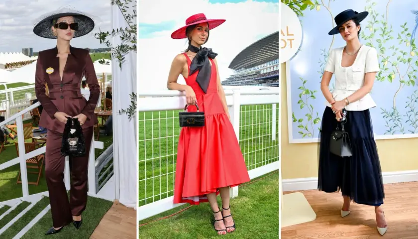 Drei Frauen in eleganten Outfits und Hüten bei einem Pferderennen.