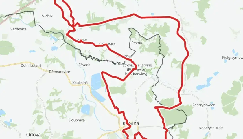 Mapa z zaznaczoną trasą rowerową, prowadzącą przez tereny z nazwami miejscowości jak Łaziska, Karviná, Zebrzydowice. W pobliżu znajduje się żelazny szlak rowerowy parking.