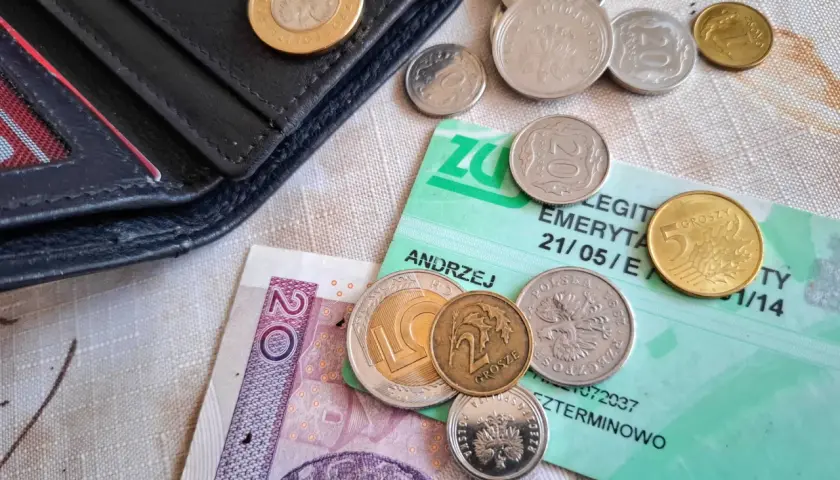 Portfel, polskie monety i banknot 20 zł na zielonej legitymacji emerytalnej. Dlaczego KO poparła reformę renty wdowiej mimo obaw o budżet?