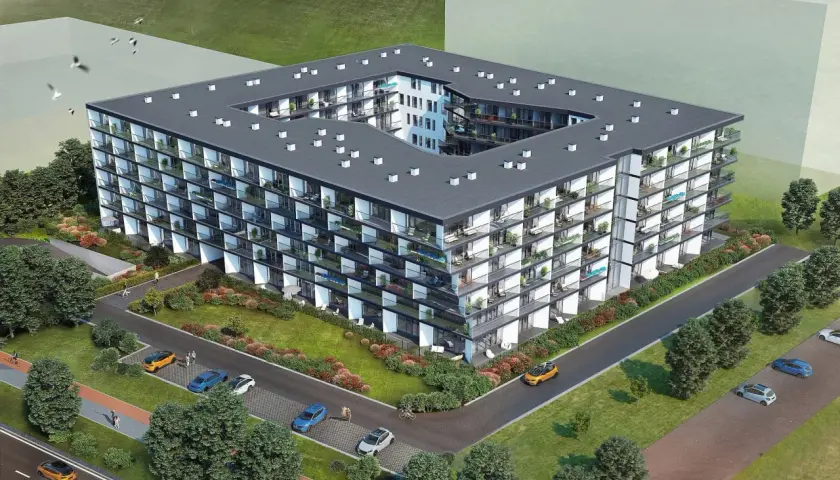 Nowoczesny budynek mieszkalny Chodźki Residence z licznymi balkonami i zielenią wokół.