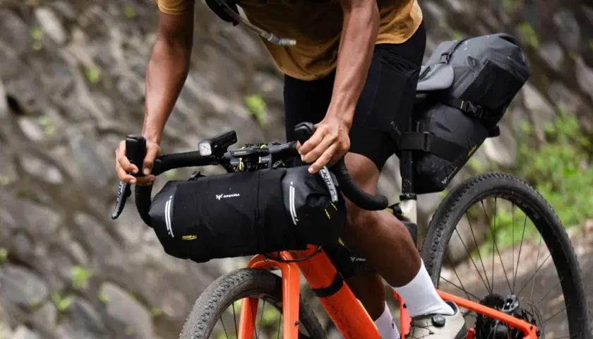 Ciclista en ruta de bikepacking carretera, con alforjas y equipo listo para la aventura.