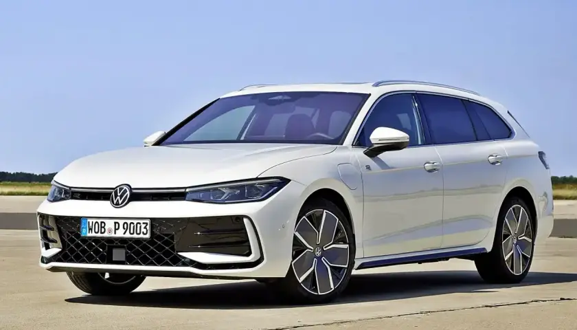 Biały Volkswagen Passat B9 Variant z nowoczesnymi felgami stoi na betonie, z błękitnym niebem w tle.
