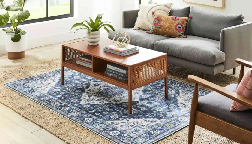 Layering a patterned blue rug over a jute rug creates depth. A 5x8 or 6x9 rug would work well to layer over an 8x10.