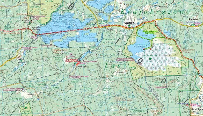 Mapa turystyczna przedstawiająca **lasy janowskie** z zaznaczonymi szlakami, rezerwatami i miejscami pamięci.