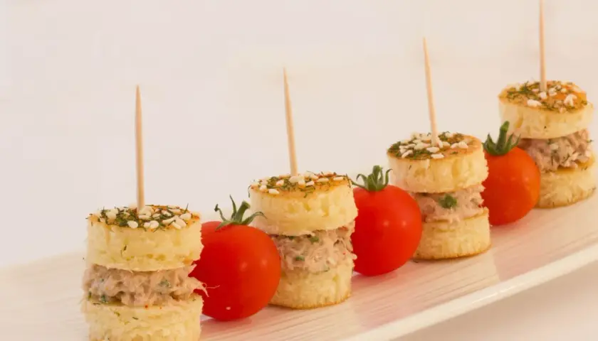 Petits pains garnis de thon, parsemés d'herbes et de sésame, accompagnés de tomates cerises. Une délicieuse brochette apéro.