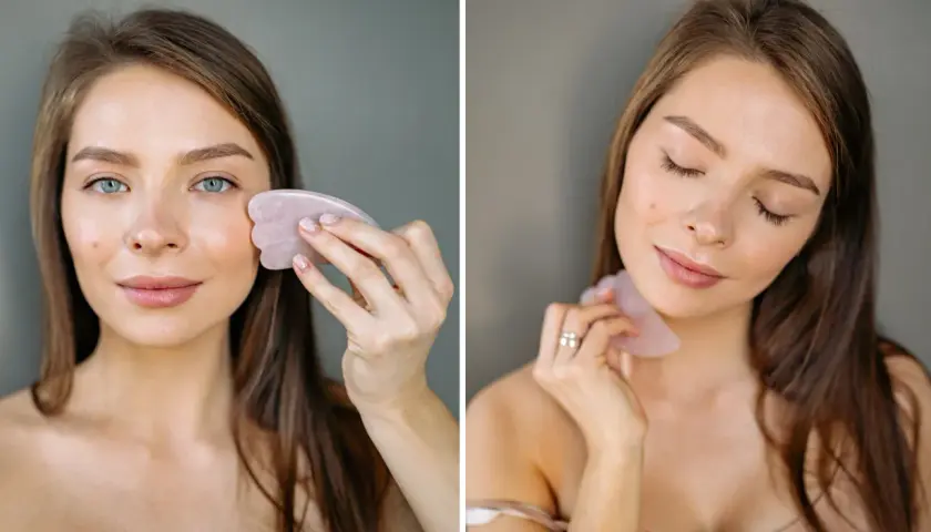 Kvinna använder en rosa gua sha för ansiktsmassage.