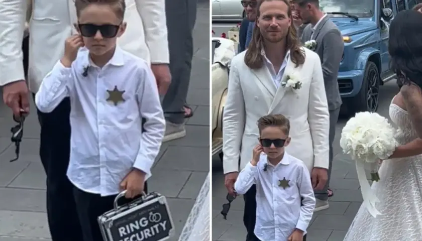 Chłopiec w okularach przeciwsłonecznych, z odznaką i walizeczką "Ring Security", towarzyszy parze młodej.