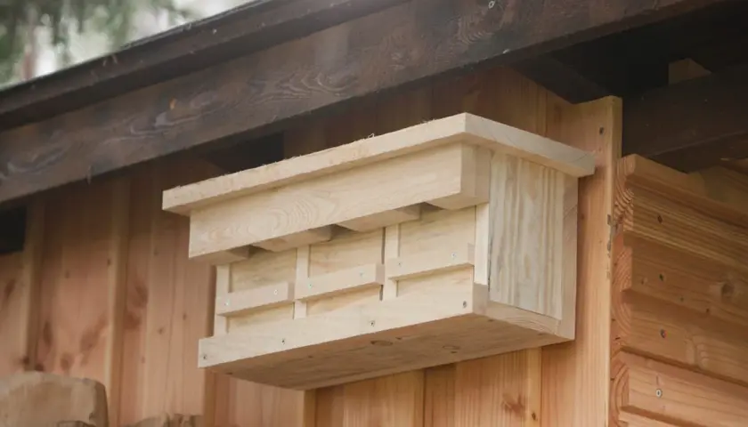 Ein selbstgebauter Nistkasten aus hellem Holz, bereit für gefiederte Gäste.