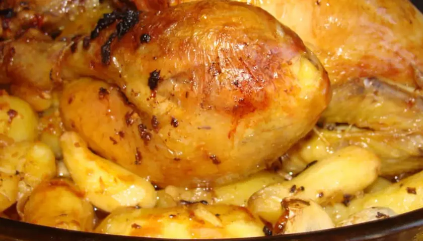 Un plat de poulet au four avec des pommes de terre dorées et juteuses, prêt à être dégusté.